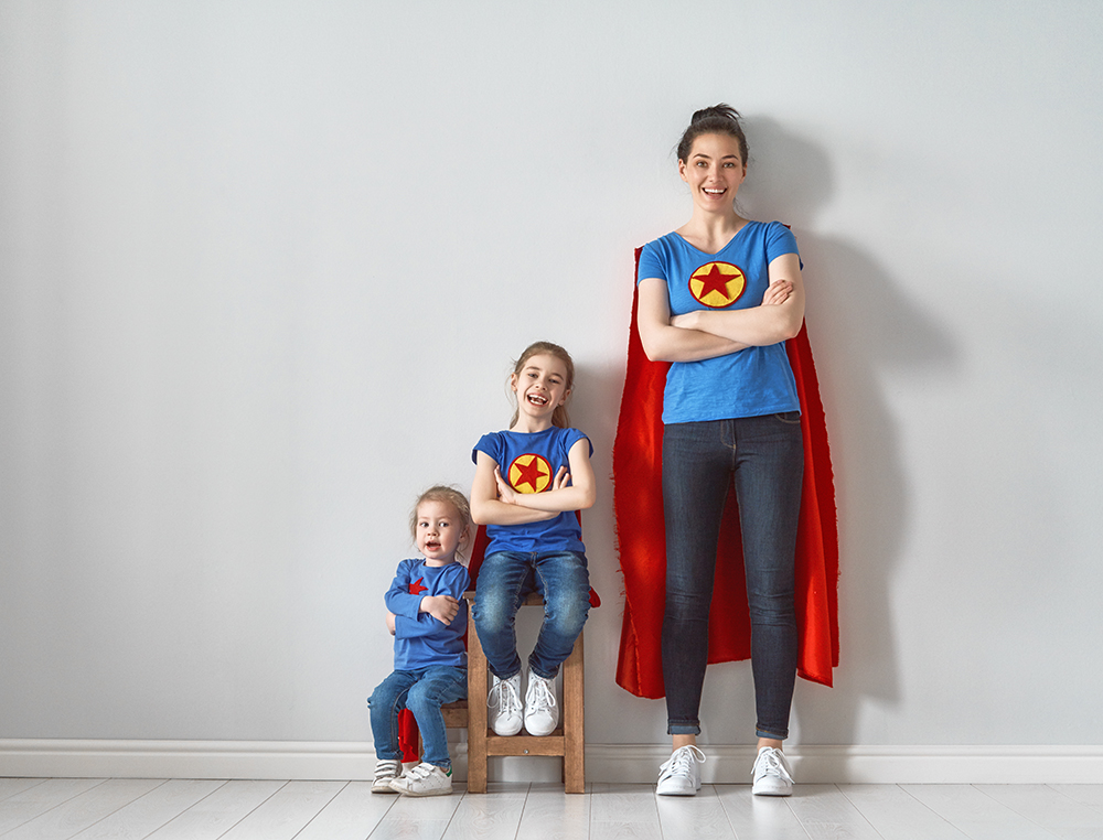 woman posting as superhero with two kids image